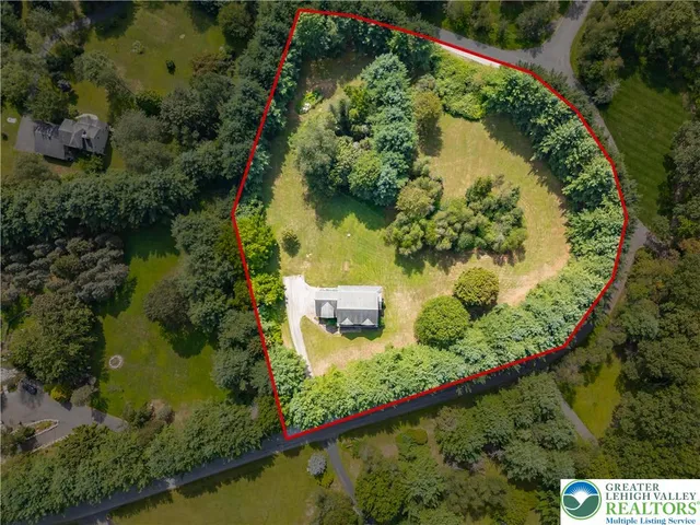 an aerial view of a residential houses with outdoor space
