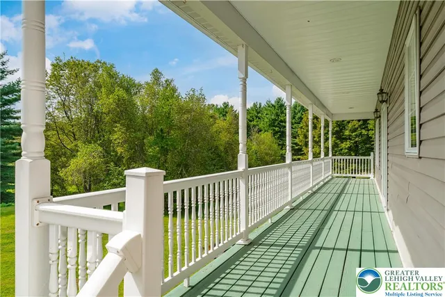 a view of balcony with wooden floor and fence