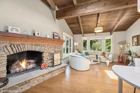 a living room with furniture a window and a fireplace