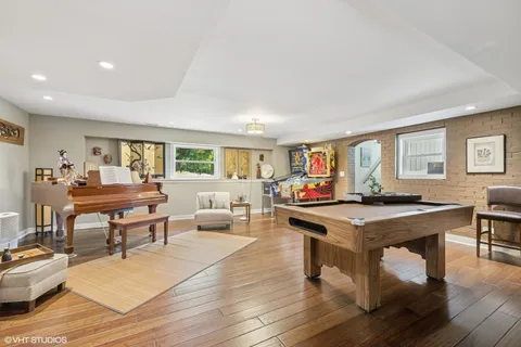 a living room with furniture a table and wooden floor