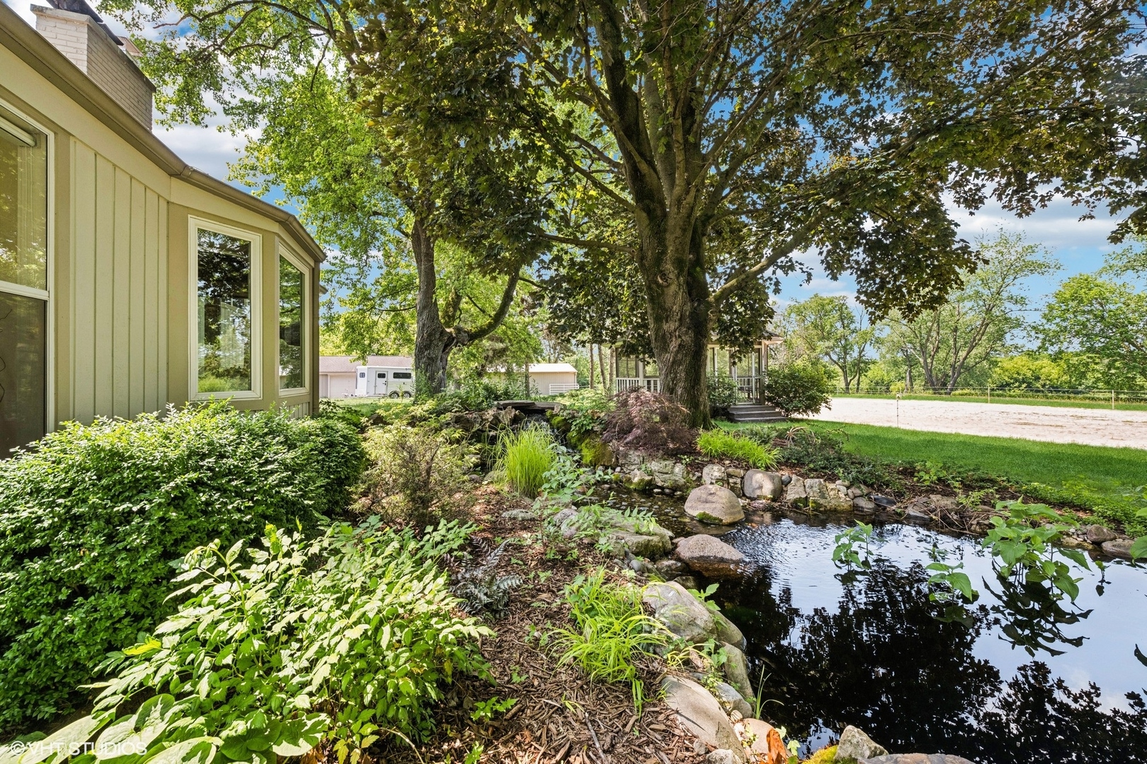 180 A Old Sutton Road Barrington Hills, IL 60010 - Photo 24 of 30 a view of a garden with a bench