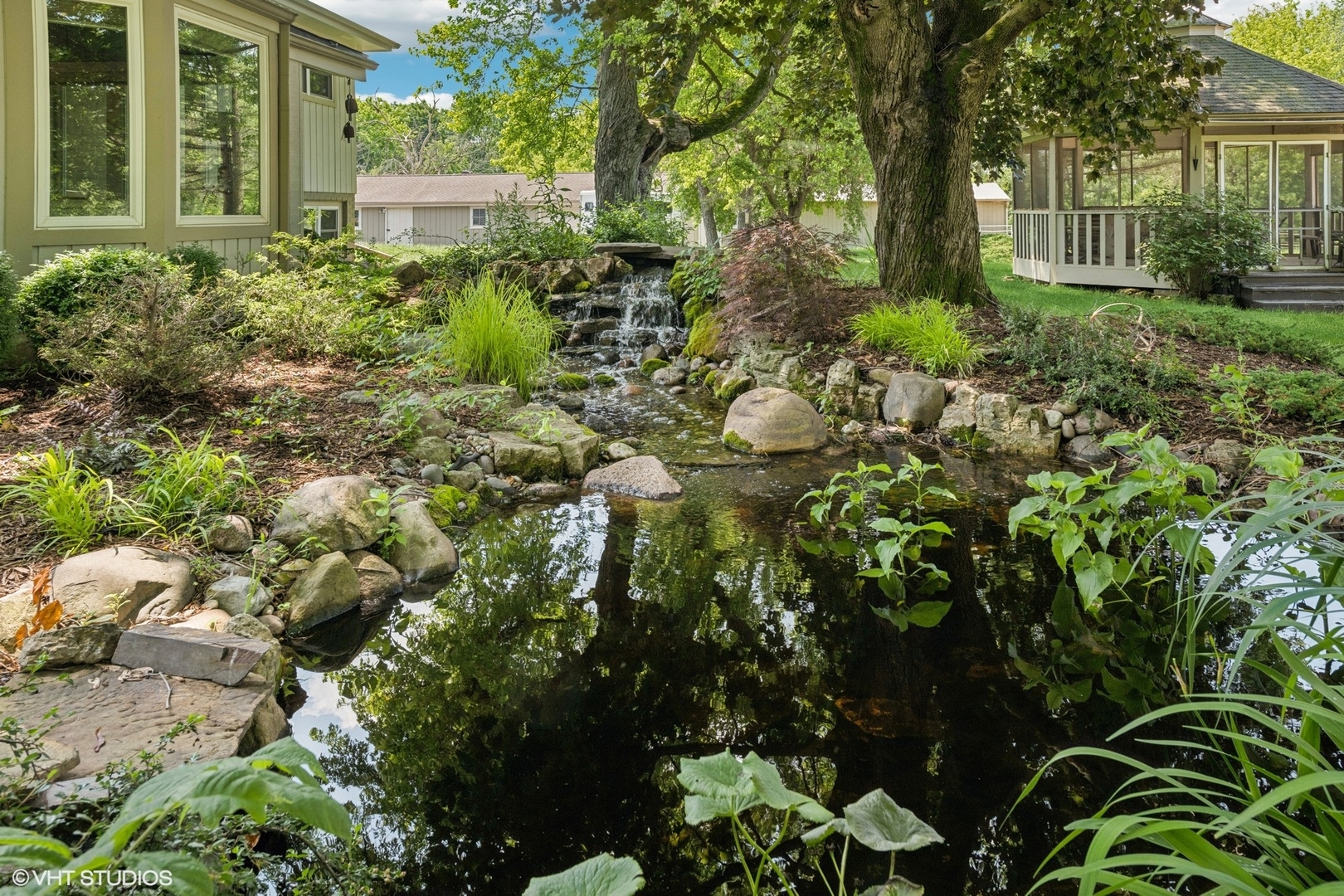 180 A Old Sutton Road Barrington Hills, IL 60010 - Photo 26 of 30 a view of a garden with plants and large trees