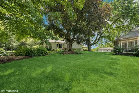 a view of an house with backyard space and garden