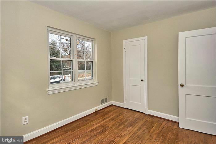 2808 Ivydale Street Silver Spring, MD 20902 - Photo 14 of 25 a view of an empty room with wooden floor and a window