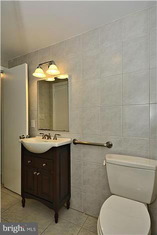 2808 Ivydale Street Silver Spring, MD 20902 - Photo 23 of 25 a bathroom with a toilet sink and mirror