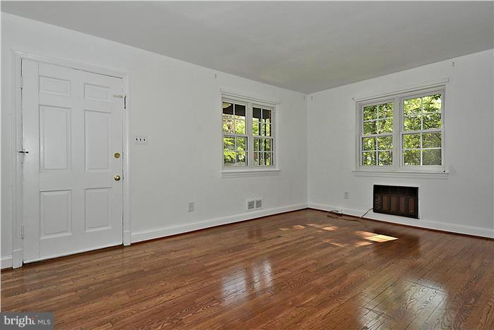 2808 Ivydale Street Silver Spring, MD 20902 - Photo 5 of 25 an empty room with wooden floor and windows