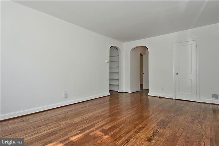 2808 Ivydale Street Silver Spring, MD 20902 - Photo 6 of 25 a view of an empty room with wooden floor and a window