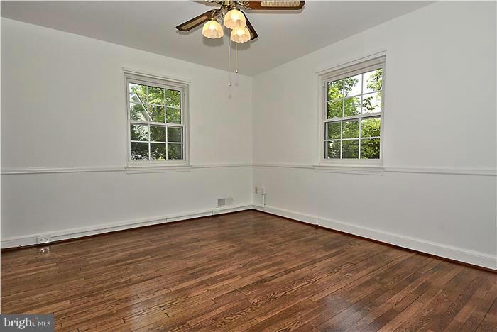 2808 Ivydale Street Silver Spring, MD 20902 - Photo 8 of 25 an empty room with wooden floor and windows