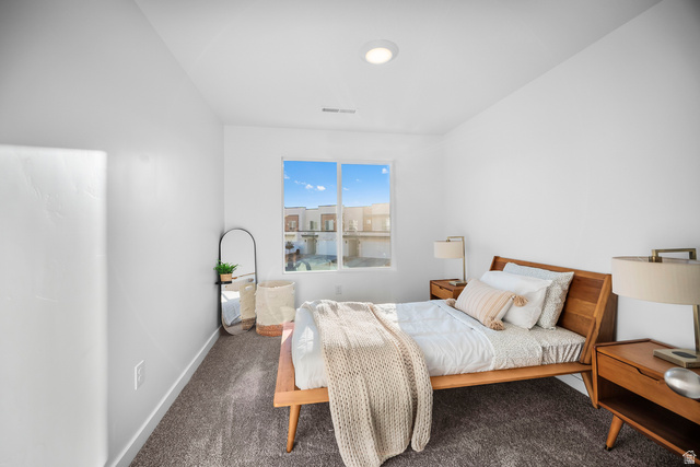 2202 Wolverine Way, Unit 2529 Washington, UT 84780 - Photo 14 of 27 Bedroom featuring a large window, neutral wall paint, recessed lighting, and grey carpet flooring
