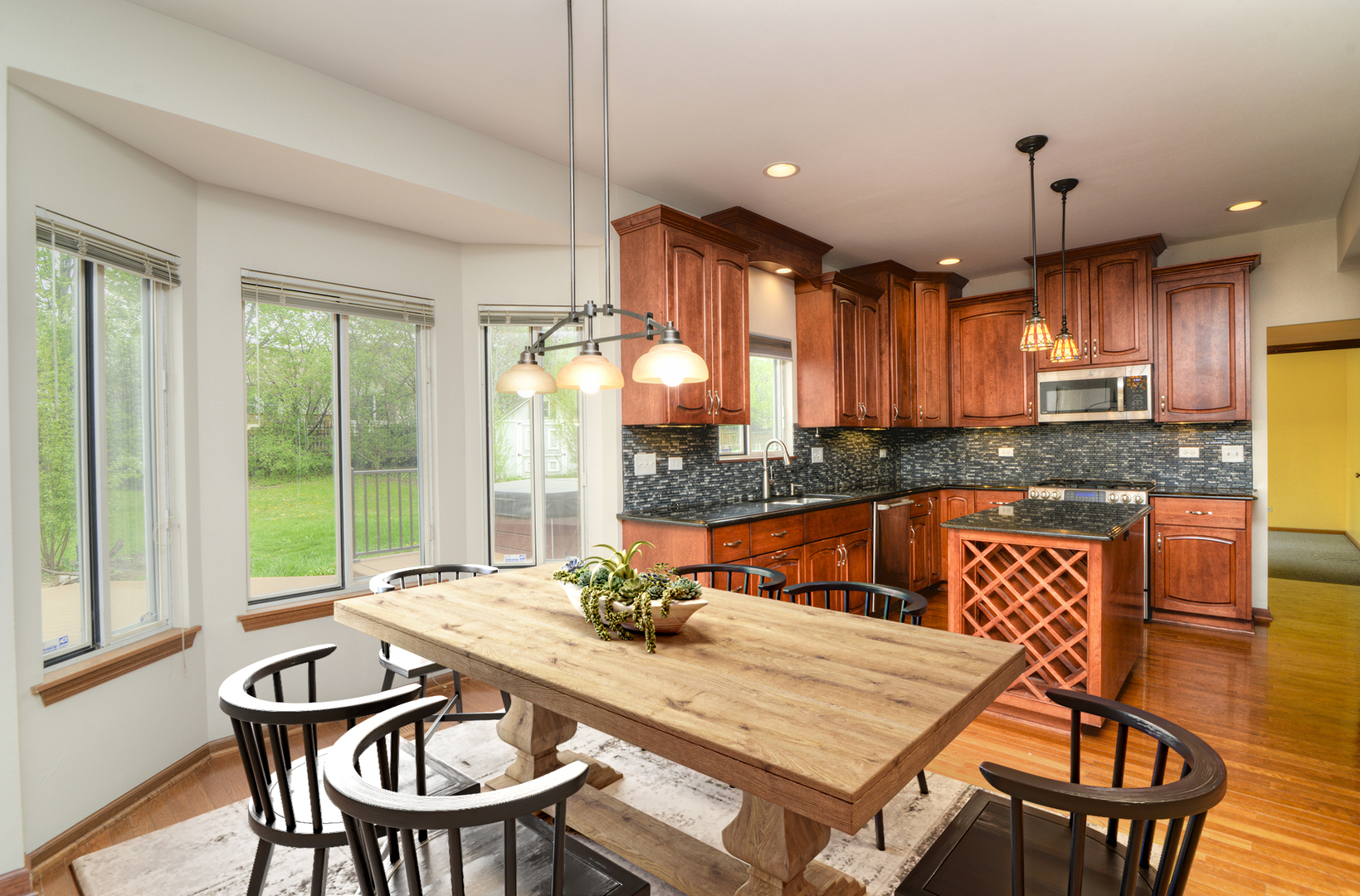 503 Yardley Drive Carol Stream, IL 60188 - Photo 12 of 41 a kitchen with a table chairs sink and cabinets