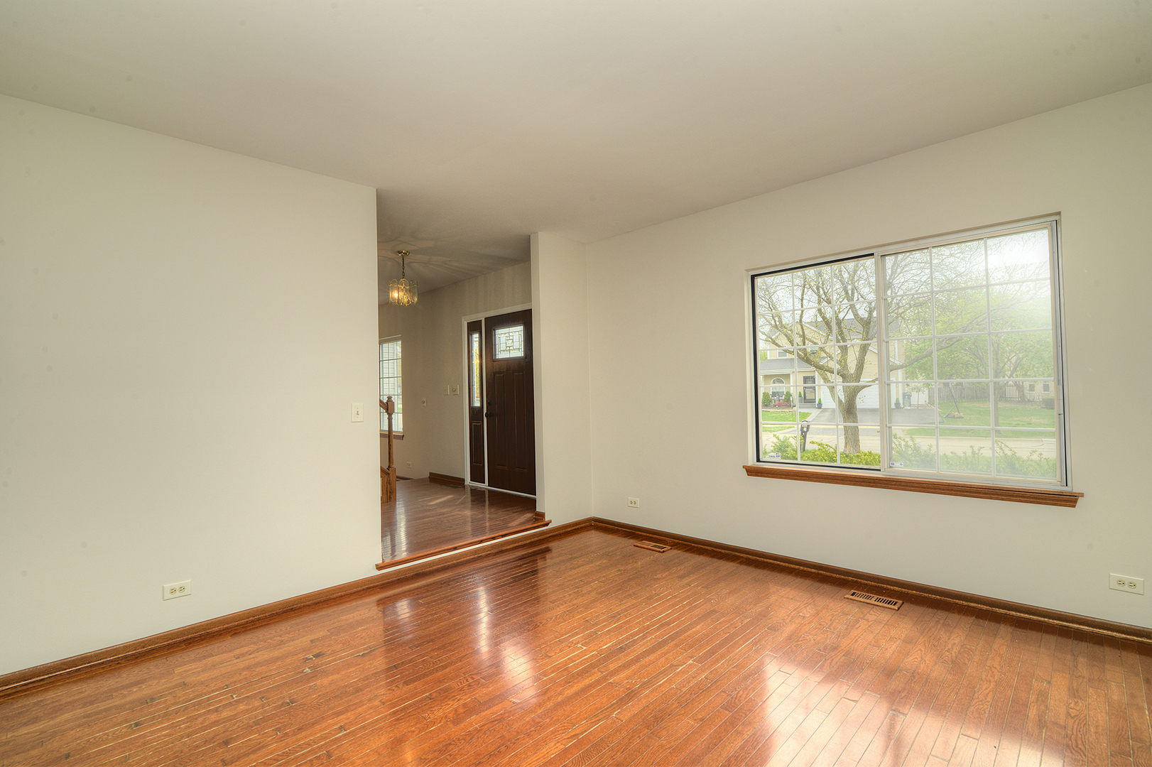 503 Yardley Drive Carol Stream, IL 60188 - Photo 6 of 41 an empty room with wooden floor and windows