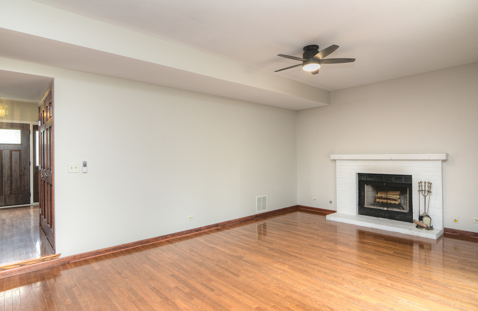 503 Yardley Drive Carol Stream, IL 60188 - Photo 9 of 41 a view of an empty room with wooden floor fireplace and a window