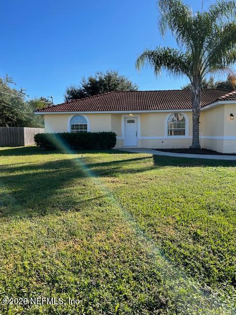 9 Lyons Place Palm Coast, FL 32137 - Photo 28 of 31 a front view of a house with a yard