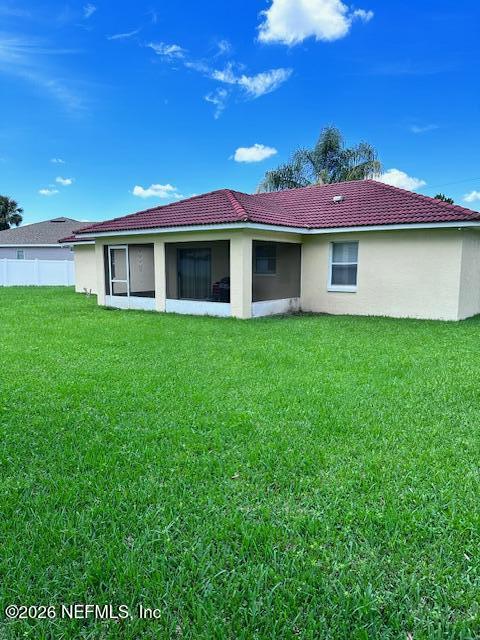 9 Lyons Place Palm Coast, FL 32137 - Photo 3 of 31 a front view of a house with a yard