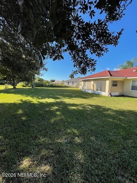 9 Lyons Place Palm Coast, FL 32137 - Photo 31 of 31 a view of a house with a big yard