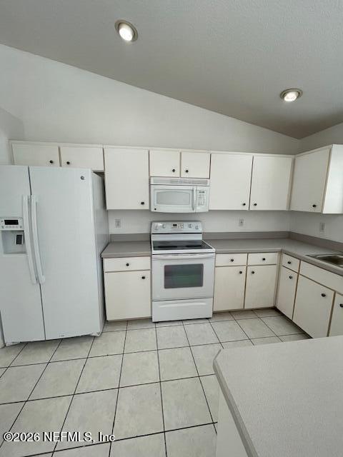 9 Lyons Place Palm Coast, FL 32137 - Photo 9 of 31 a kitchen with cabinets and white appliances