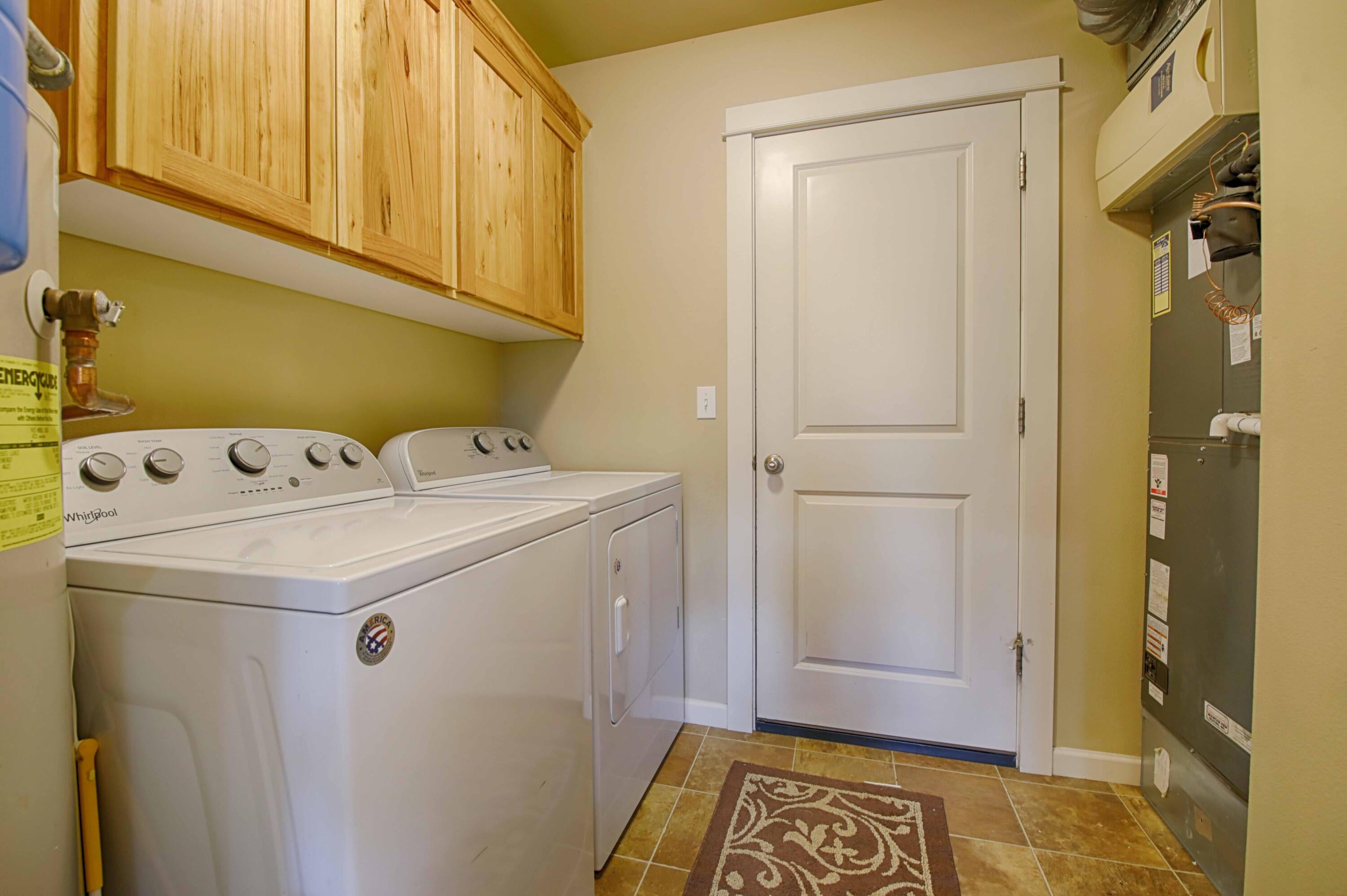 64818 Grande Loop Bend, OR 97701 - Photo 11 of 29 Laundry room with storage, located just inside garage door.