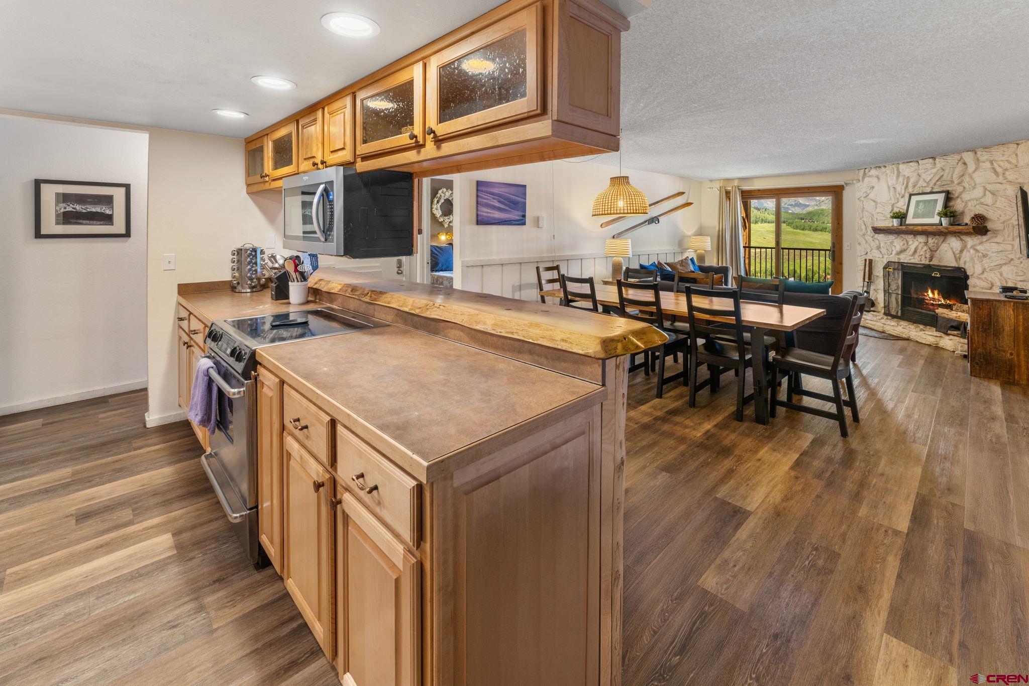 72 Hunter Hill Road, Unit I204 Crested Butte, CO 81225 - Photo 3 of 44 a kitchen with stainless steel appliances granite countertop a stove and a wooden floors