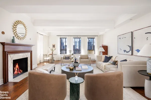 a living room with furniture a fireplace and a large mirror