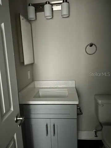 a white toilet sitting next to a bath tub