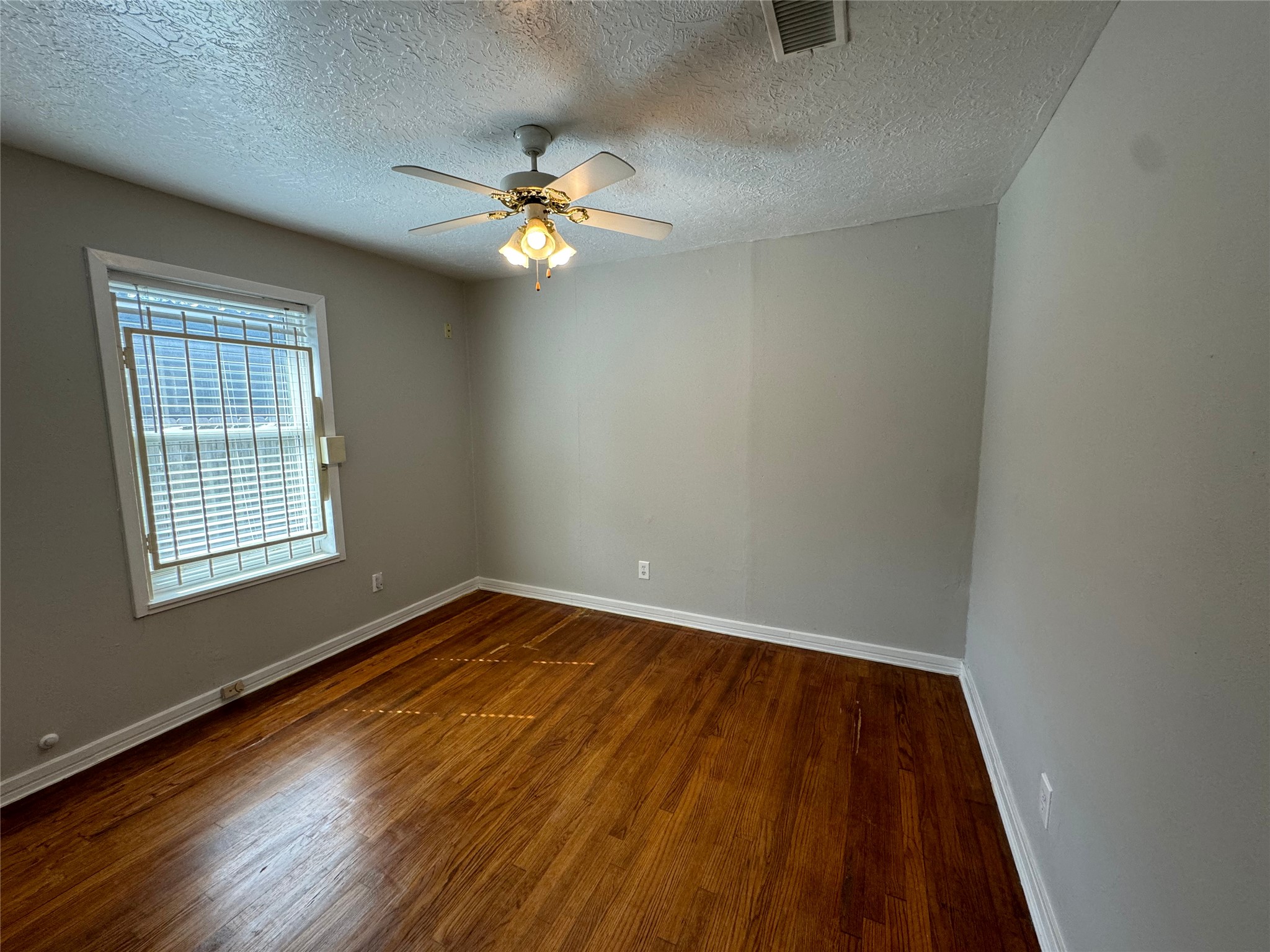 125 Pomeroy Street Pasadena, TX 77506 - Photo 17 of 19 wooden floor in an empty room with a window