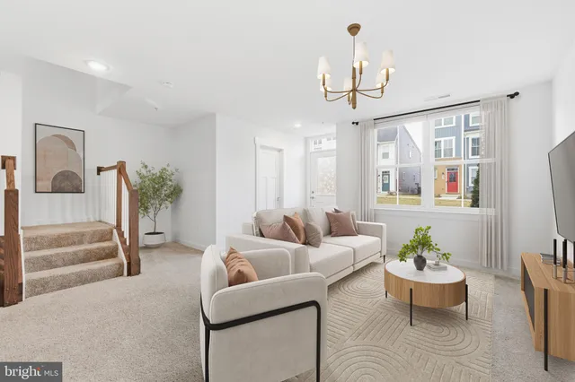 a living room with furniture a chandelier and a chandelier