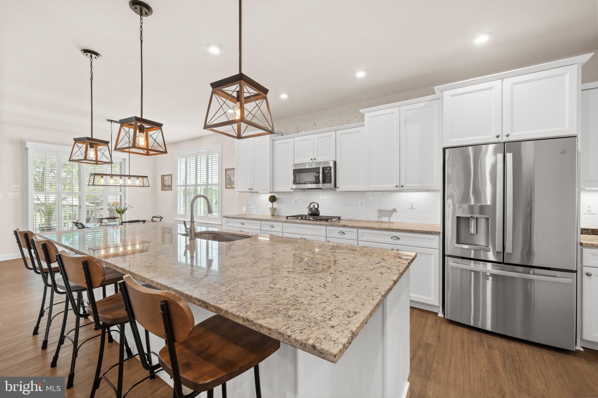 355 Dillon Circle Middletown, DE 19709 - Photo 18 of 84 a kitchen with stainless steel appliances granite countertop a kitchen island a stove a table and chairs