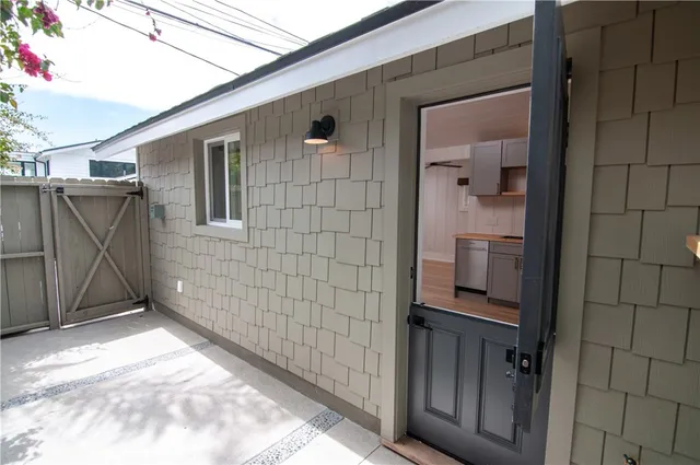 a kitchen with stainless steel appliances granite countertop a sink a stove and a refrigerator with wooden floor