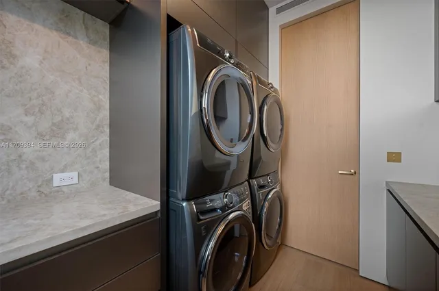 a bedroom with furniture and large windows