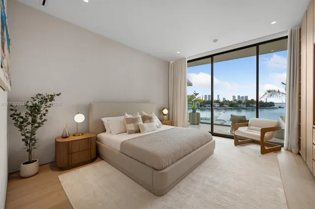 a bedroom with a large bed and a large window