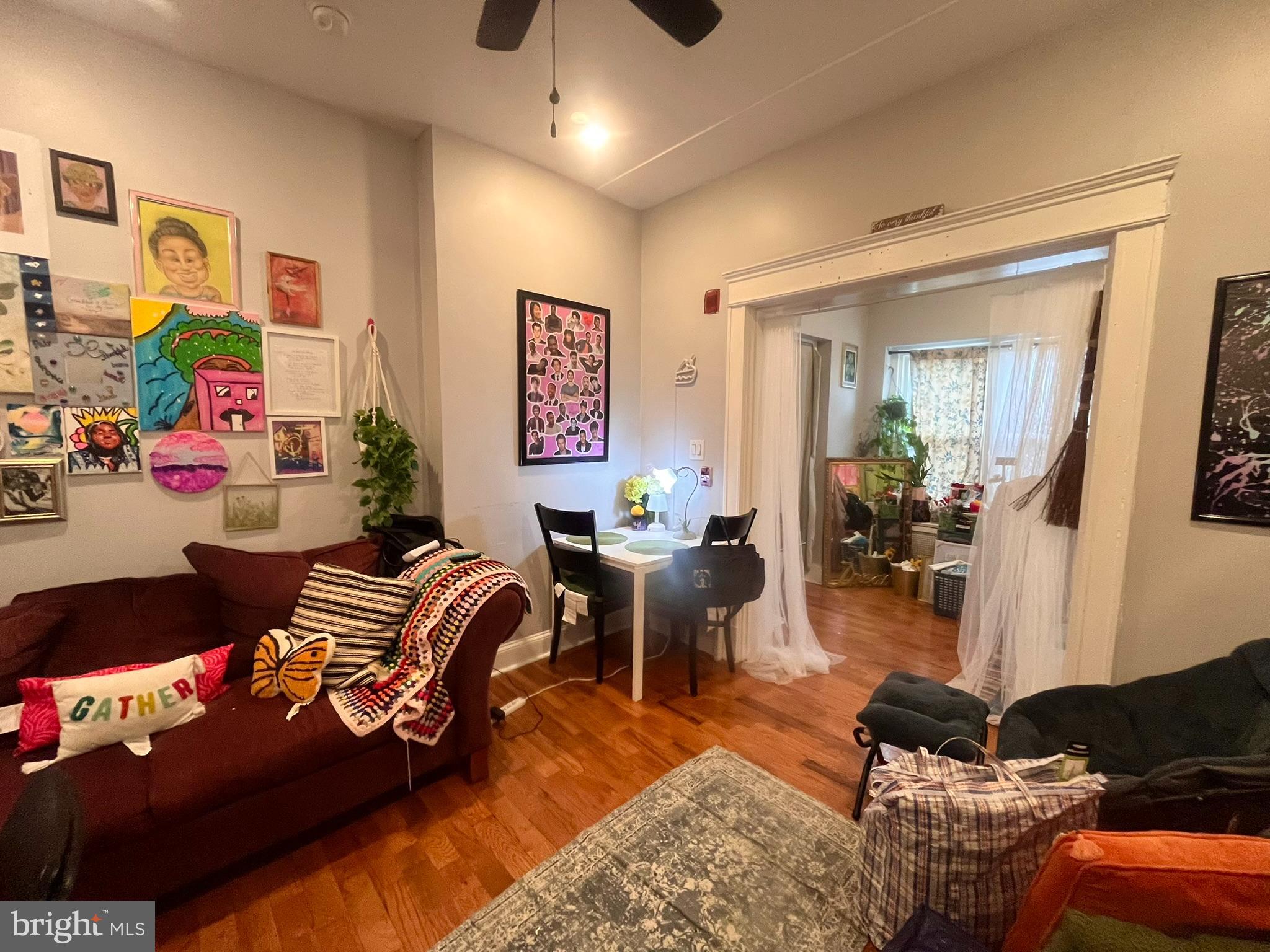 5028 Walnut Street, Unit 1F Philadelphia, PA 19139 - Photo 14 of 32 a living room with furniture and wooden floor
