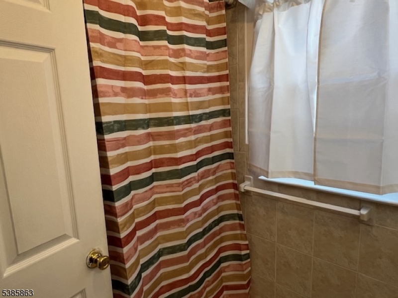 45 2nd Street Newark, NJ 07107 - Photo 14 of 32 a bathroom with a sink and a shower curtain