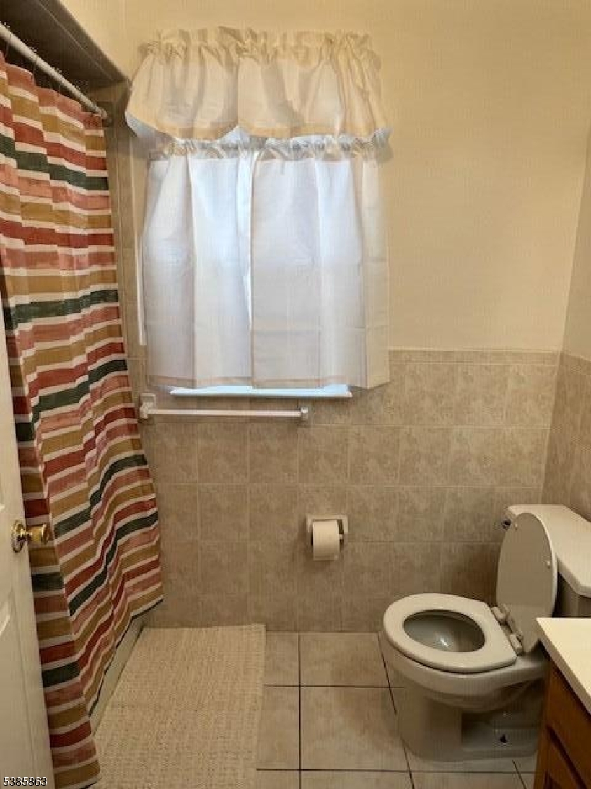 45 2nd Street Newark, NJ 07107 - Photo 15 of 32 a bathroom with a toilet and a shower curtain