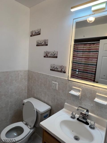 45 2nd Street Newark, NJ 07107 - Photo 16 of 32 a bathroom with a sink a toilet and mirror