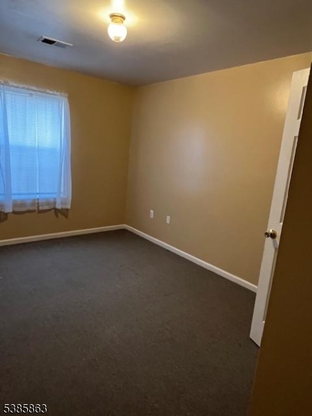 45 2nd Street Newark, NJ 07107 - Photo 19 of 32 an empty room with a wooden door