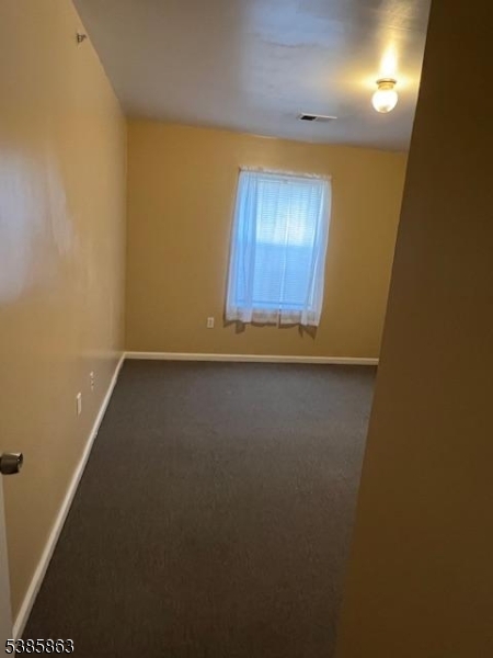 45 2nd Street Newark, NJ 07107 - Photo 20 of 32 an empty room with wooden floor and windows