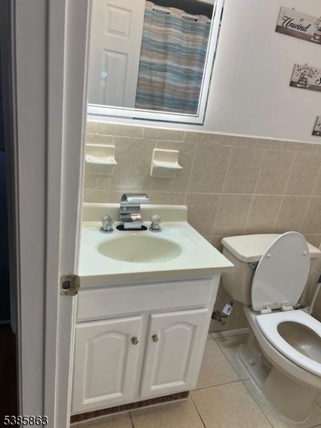 45 2nd Street Newark, NJ 07107 - Photo 24 of 32 a bathroom with a sink a toilet and a mirror