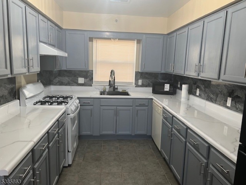 45 2nd Street Newark, NJ 07107 - Photo 3 of 32 a kitchen with a sink stove top oven and cabinets