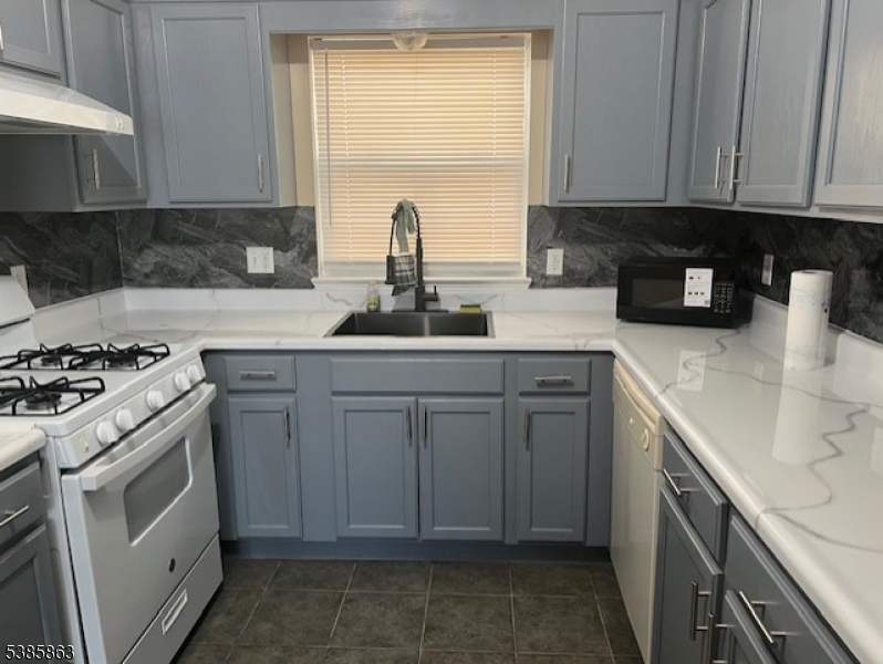 45 2nd Street Newark, NJ 07107 - Photo 10 of 32 a kitchen with a sink stove and cabinets