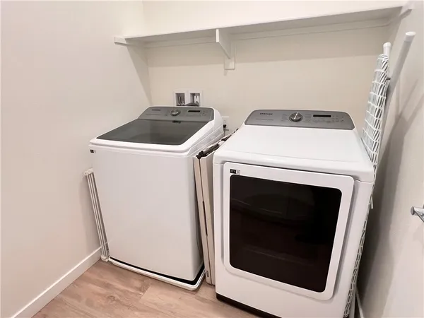 a view of a hallway with washer and dryer