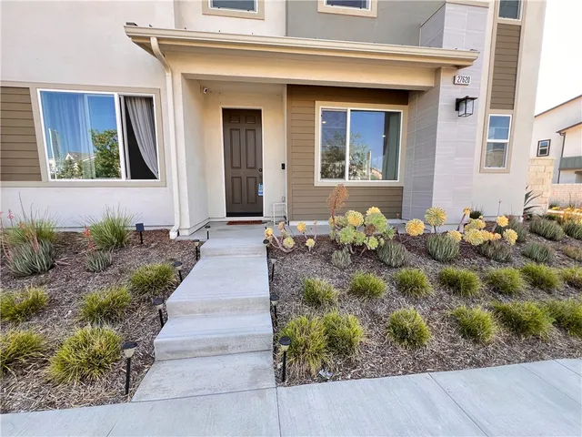a front view of a house with a yard and a garage