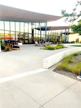 a view of a patio with a table and chairs under an umbrella