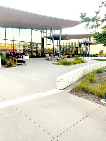 a view of a patio with a table and chairs under an umbrella