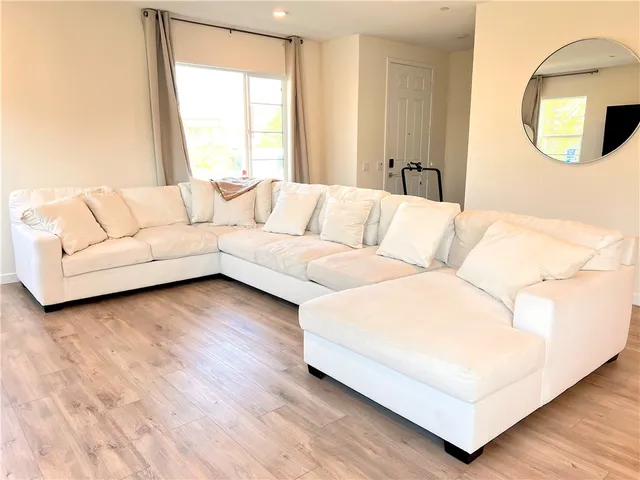 a living room with furniture and a large window