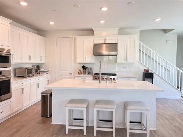 a large kitchen with a table and chairs