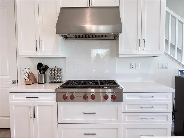 a kitchen with a stove and a refrigerator