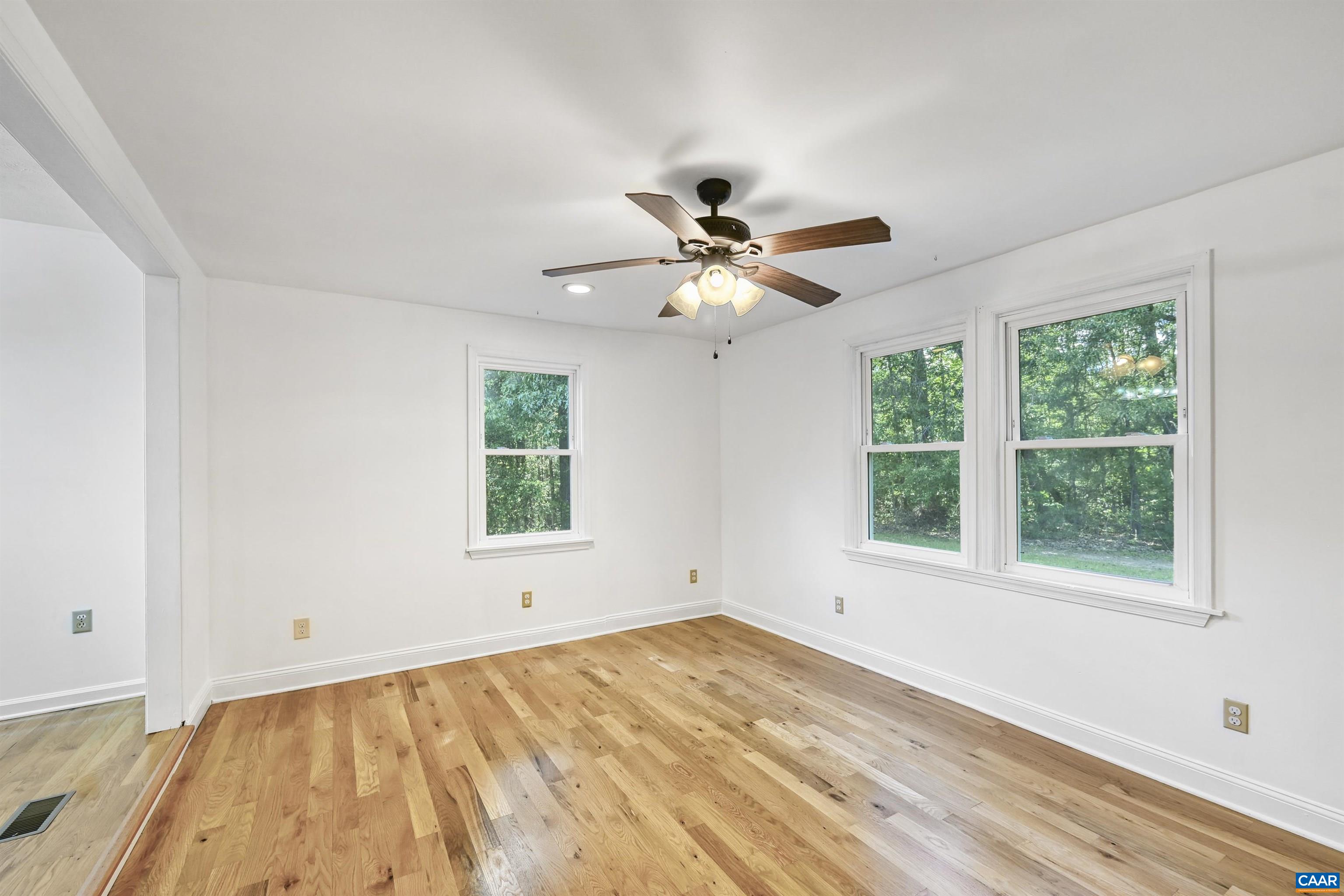 2445 Eastham Road Bumpass, VA 23024 - Photo 23 of 29 a view of an empty room with wooden floor and a window