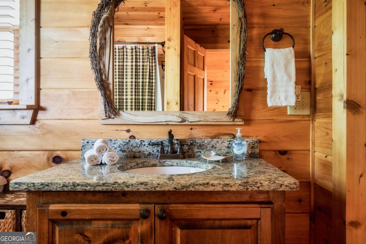 273 Deer Crest Heights Blue Ridge, GA 30513 - Photo 36 of 73 a bathroom with a granite countertop sink and a window