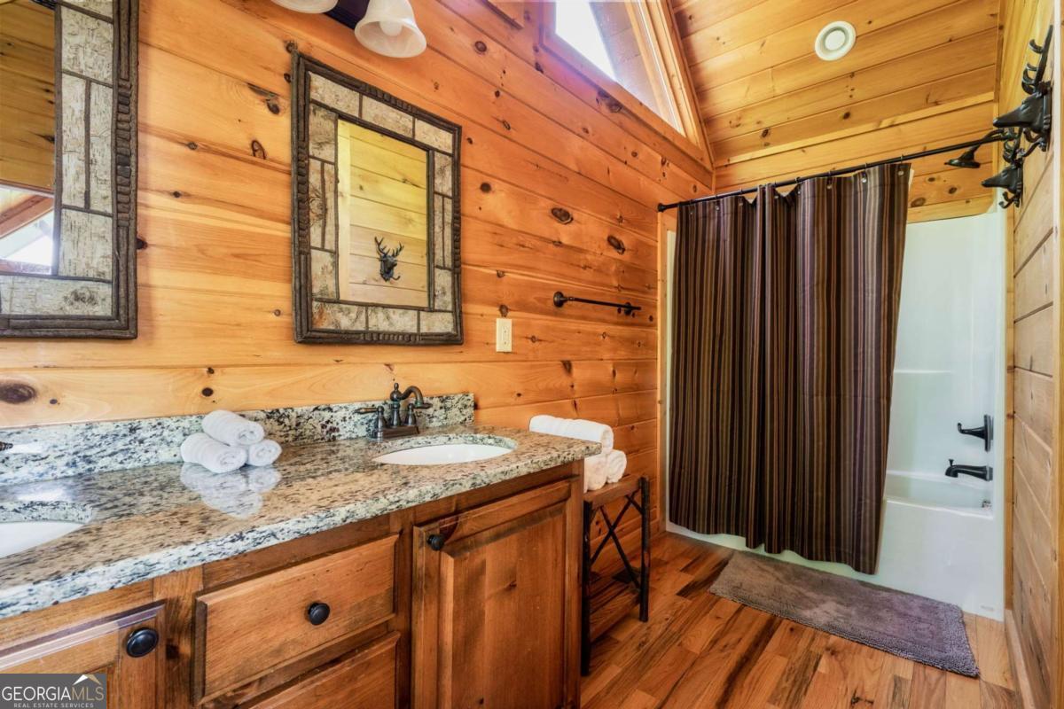 273 Deer Crest Heights Blue Ridge, GA 30513 - Photo 47 of 73 a bathroom with a granite countertop sink a mirror and shower