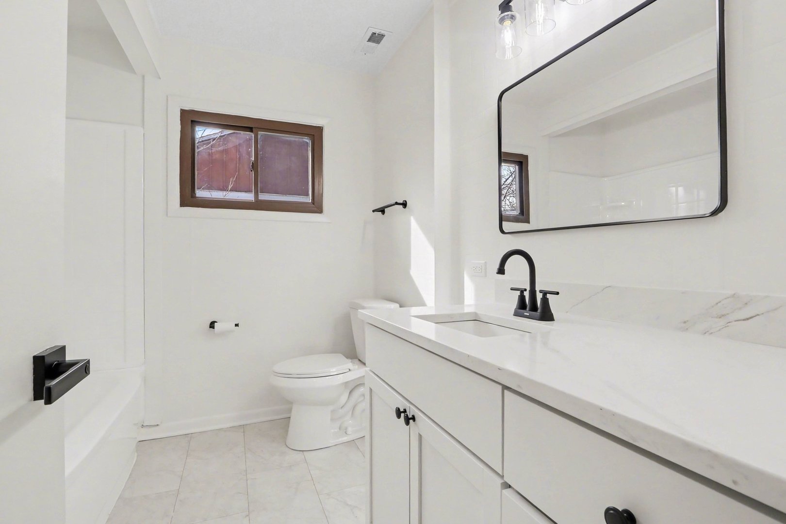629 Thornton Street Lockport, IL 60441 - Photo 13 of 15 a bathroom with a toilet sink and mirror